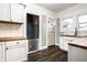 Bright kitchen features white cabinets, wood countertops, and a dog gate to the basement at 309 N Riley Ave, Indianapolis, IN 46201