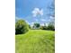 Expansive back yard featuring a lush lawn and a view of the rear of the house at 3414 Rost Dr, Columbus, IN 47203