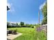 Expansive back yard featuring a patio with wicker furniture and lush green grass at 3414 Rost Dr, Columbus, IN 47203