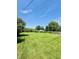 Large back yard featuring a lush lawn, mature trees, and ample space for recreation at 3414 Rost Dr, Columbus, IN 47203