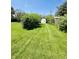 Back yard featuring a lawn, lush green grass, and a shed at 3414 Rost Dr, Columbus, IN 47203