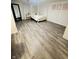 Spacious basement bedroom featuring vinyl flooring, brick accent wall, and ample natural light at 3414 Rost Dr, Columbus, IN 47203