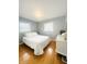 Cozy bedroom featuring a queen-sized bed, white walls and accents, and gleaming hardwood floors at 3414 Rost Dr, Columbus, IN 47203