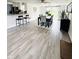 Open dining area with hard surface floors and modern black dining table with six upholstered chairs at 3414 Rost Dr, Columbus, IN 47203