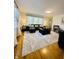 Open living room area with hardwood floors, neutral walls, and a decorative area rug at 3414 Rost Dr, Columbus, IN 47203