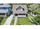 Aerial view of a well-maintained property with a charming front porch and green surroundings at 344 N Whittier Pl, Indianapolis, IN 46219