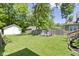 The serene backyard includes a well-maintained lawn and lush trees, offering a peaceful retreat at 344 N Whittier Pl, Indianapolis, IN 46219
