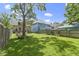 This picturesque backyard has green grass, mature trees, and a seating area, creating a relaxing space at 344 N Whittier Pl, Indianapolis, IN 46219