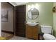 This charming bathroom has a classic sink vanity, a round mirror, and decorative touches at 344 N Whittier Pl, Indianapolis, IN 46219