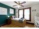 Charming bedroom featuring hardwood floors, ceiling fan, artwork, and built-in drawers at 344 N Whittier Pl, Indianapolis, IN 46219