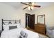 Comfortable bedroom with ceiling fan, dresser, and neutral tones offering a relaxing retreat at 344 N Whittier Pl, Indianapolis, IN 46219