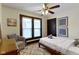 Serene bedroom featuring a cozy armchair, hardwood floors, ceiling fan and neutral decor at 344 N Whittier Pl, Indianapolis, IN 46219