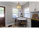 Cozy breakfast nook with white table, natural light from two windows, and beaded chandelier at 344 N Whittier Pl, Indianapolis, IN 46219