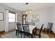 Elegant dining room featuring hardwood floors, a decorative rug, and updated light fixture adding charm at 344 N Whittier Pl, Indianapolis, IN 46219