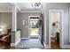Inviting foyer featuring hardwood floors, a decorative rug, and view of the front yard at 344 N Whittier Pl, Indianapolis, IN 46219