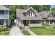 Charming home showcasing a well-manicured lawn and welcoming front porch at 344 N Whittier Pl, Indianapolis, IN 46219