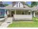 Inviting front porch with classic design elements, complemented by a well-manicured lawn at 344 N Whittier Pl, Indianapolis, IN 46219