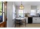 Bright breakfast nook with a charming round table, modern lighting, and views into the updated kitchen at 344 N Whittier Pl, Indianapolis, IN 46219