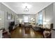 Bright living room featuring hardwood floors, recessed lighting, large sectional couch, and a decorative light fixture at 344 N Whittier Pl, Indianapolis, IN 46219