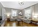 Bright living room featuring hardwood floors, recessed lighting, large sectional couch, and a decorative light fixture at 344 N Whittier Pl, Indianapolis, IN 46219