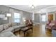 Open-concept living room featuring a comfortable gray sectional couch, hardwood floors, and natural light at 344 N Whittier Pl, Indianapolis, IN 46219