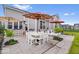 Backyard featuring a spacious patio with sun umbrellas, an outdoor dining area, and lounge furniture at 3463 Sunnyvale Dr, Brownsburg, IN 46112