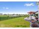Backyard featuring green lawn, black fencing, patio, and outdoor dining set with serene pond views at 3463 Sunnyvale Dr, Brownsburg, IN 46112