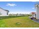 Spacious backyard with black fencing overlooking a serene pond at 3463 Sunnyvale Dr, Brownsburg, IN 46112