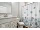 Functional bathroom features a vanity with modern fixtures and a shower with floral curtain at 3463 Sunnyvale Dr, Brownsburg, IN 46112