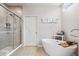 Modern bathroom featuring a glass-enclosed shower and a standalone soaking tub at 3463 Sunnyvale Dr, Brownsburg, IN 46112