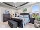 Cozy bedroom with dark wood furnishings, tray ceiling, and comfortable blue bedding at 3463 Sunnyvale Dr, Brownsburg, IN 46112