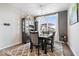 Dining room features large windows, a modern light fixture, and a china cabinet for storage at 3463 Sunnyvale Dr, Brownsburg, IN 46112
