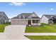 Charming home with a three-car garage, well-maintained lawn, and welcoming front porch seating at 3463 Sunnyvale Dr, Brownsburg, IN 46112