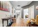 Bright hallway leading to various rooms, enhanced with decorative art and modern furnishings, creating an inviting atmosphere at 3463 Sunnyvale Dr, Brownsburg, IN 46112