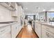Well-lit kitchen featuring white cabinetry, stone countertops, stainless steel appliances, and hardwood flooring at 3463 Sunnyvale Dr, Brownsburg, IN 46112