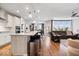 Open-concept kitchen flowing into the living area, featuring a large island, modern appliances, and ample counter space at 3463 Sunnyvale Dr, Brownsburg, IN 46112