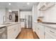 Modern kitchen featuring white cabinetry, stainless steel appliances, stone countertops, and hardwood floors at 3463 Sunnyvale Dr, Brownsburg, IN 46112