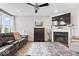 Bright living room with fireplace, large windows, and comfortable seating at 3463 Sunnyvale Dr, Brownsburg, IN 46112