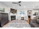 Comfortable living room featuring a fireplace, ceiling fan, and open access to the kitchen at 3463 Sunnyvale Dr, Brownsburg, IN 46112