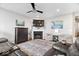 Cozy living room with a fireplace, ceiling fan, and plush seating at 3463 Sunnyvale Dr, Brownsburg, IN 46112