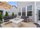 Back patio with a modern fire pit, comfortable sofas and chairs, and sunny views at 3463 Sunnyvale Dr, Brownsburg, IN 46112