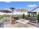 Outdoor patio featuring dining table, comfortable seating area, fire pit, heater, and beautiful pond views at 3463 Sunnyvale Dr, Brownsburg, IN 46112