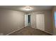 This bedroom has tan paint, base trim and carpet and includes a closet with bi-fold doors at 3742 N Wittfield St, Indianapolis, IN 46235