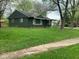 Side view of a single-story home with a well-manicured lawn and mature trees at 3742 N Wittfield St, Indianapolis, IN 46235