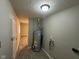 Hallway view with a water heater and access to other areas of the home at 3742 N Wittfield St, Indianapolis, IN 46235
