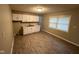 Well-lit kitchen with white cabinets, updated countertops, and luxury vinyl floors at 3742 N Wittfield St, Indianapolis, IN 46235