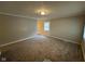 Cozy living room featuring neutral walls, plush carpet, and ample natural light at 3742 N Wittfield St, Indianapolis, IN 46235