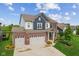 Charming two-story home boasts a well-kept lawn, a three-car garage, and serene pond view at 3948 Saddle Club S Pkwy, Bargersville, IN 46106