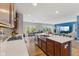 Bright, open kitchen with island, and breakfast bar flowing into the dining and living spaces at 3948 Saddle Club S Pkwy, Bargersville, IN 46106