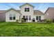 Spacious backyard featuring a well-manicured lawn and a cozy patio with outdoor furniture at 4367 Homestead Dr, Whitestown, IN 46075